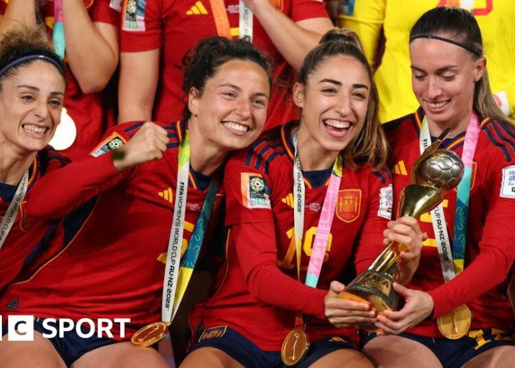 Ivana Andres, Olga Carmona and Eva Navarro of Spain celebrate with the trophy during the FIFA Women's World Cup