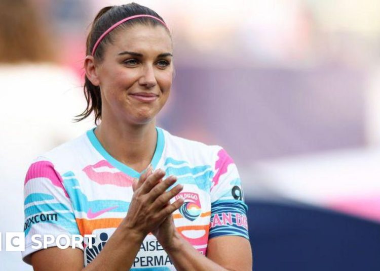 Alex Morgan claps to the crowd during her last game